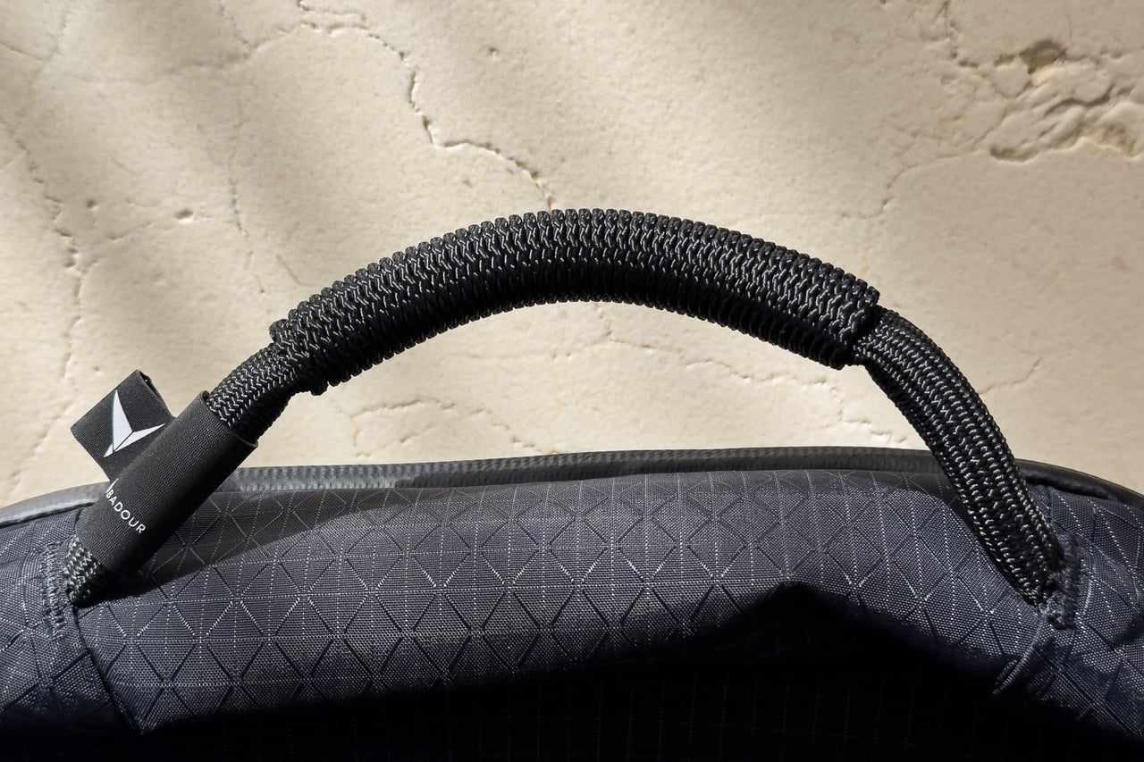 Close-up of the Troubadour Elemental Backpack's rope-style grab handle - Luxe Digital