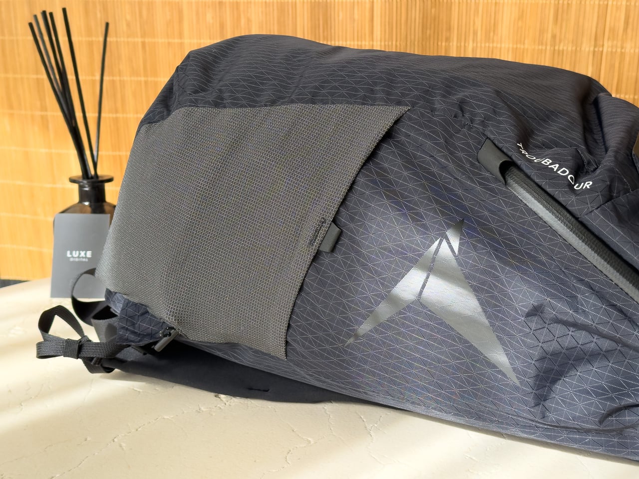 The ripstop nylon shell and side pocket of the Troubadour Elemental Backpack, up close - Luxe Digital