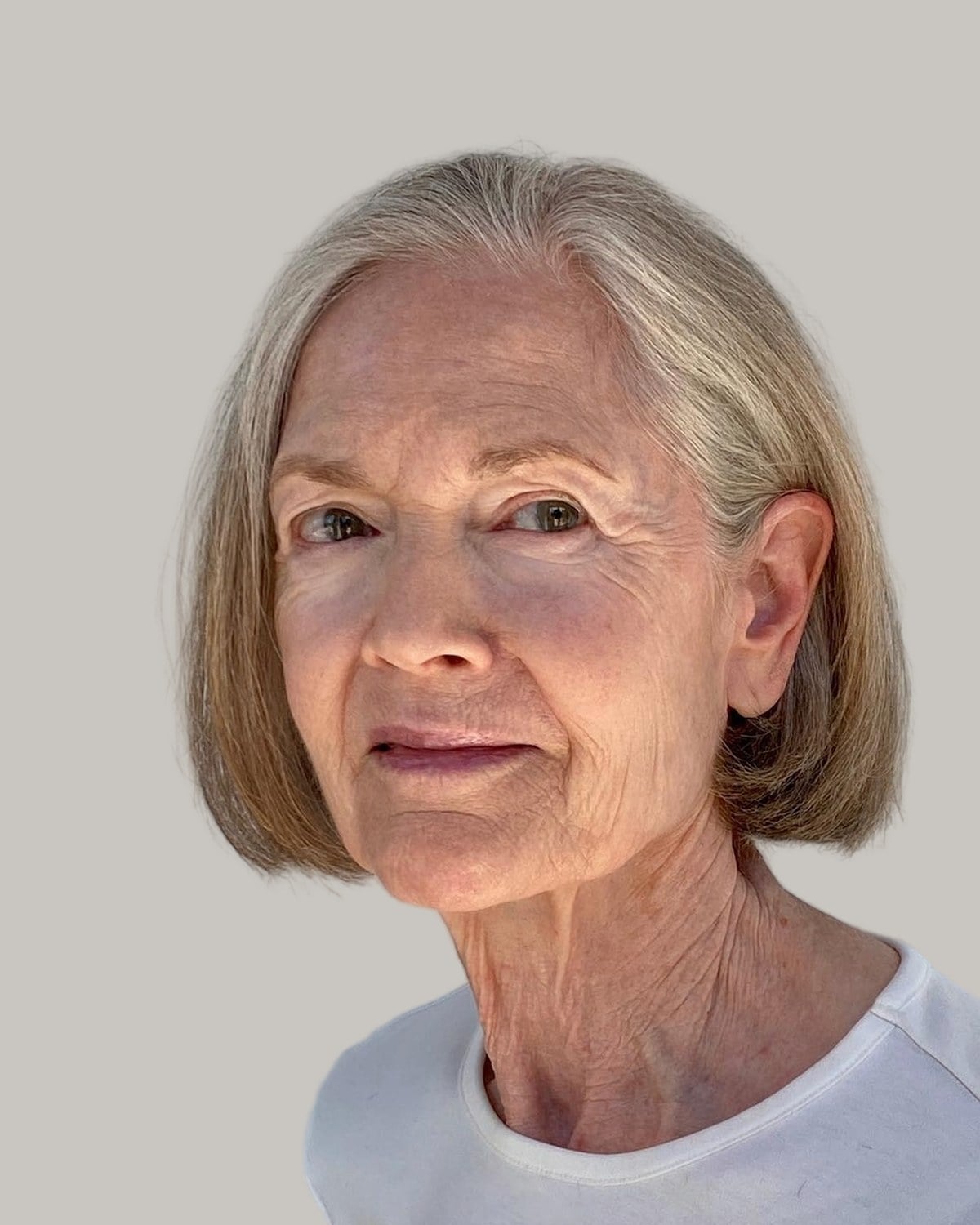 Older woman with a sandy chin-length bob and a side part, facing the camera