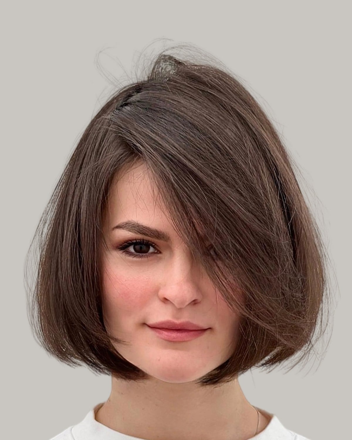 Woman with a brown rounded bob and a side-swept front, facing the camera