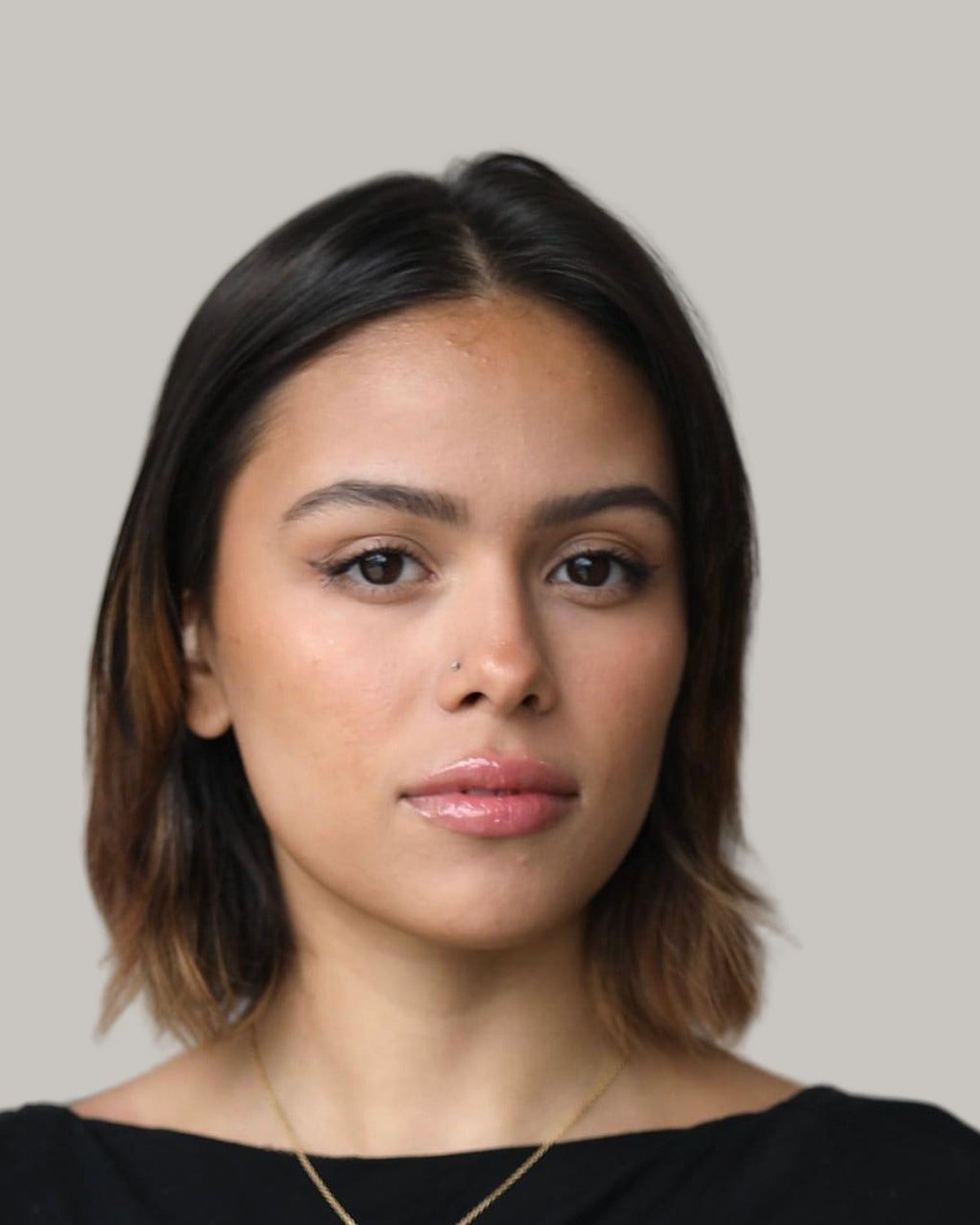 Woman with a dark brown short bob and a middle part, facing the camera