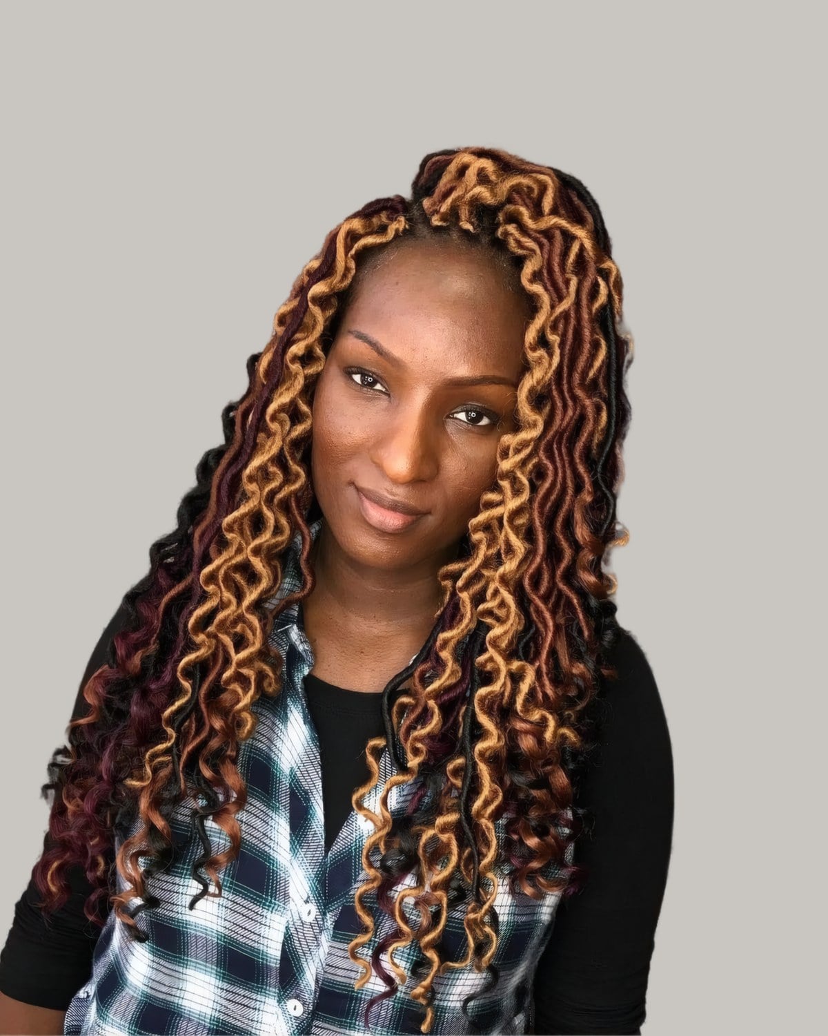 Woman with long curly locs in copper and black