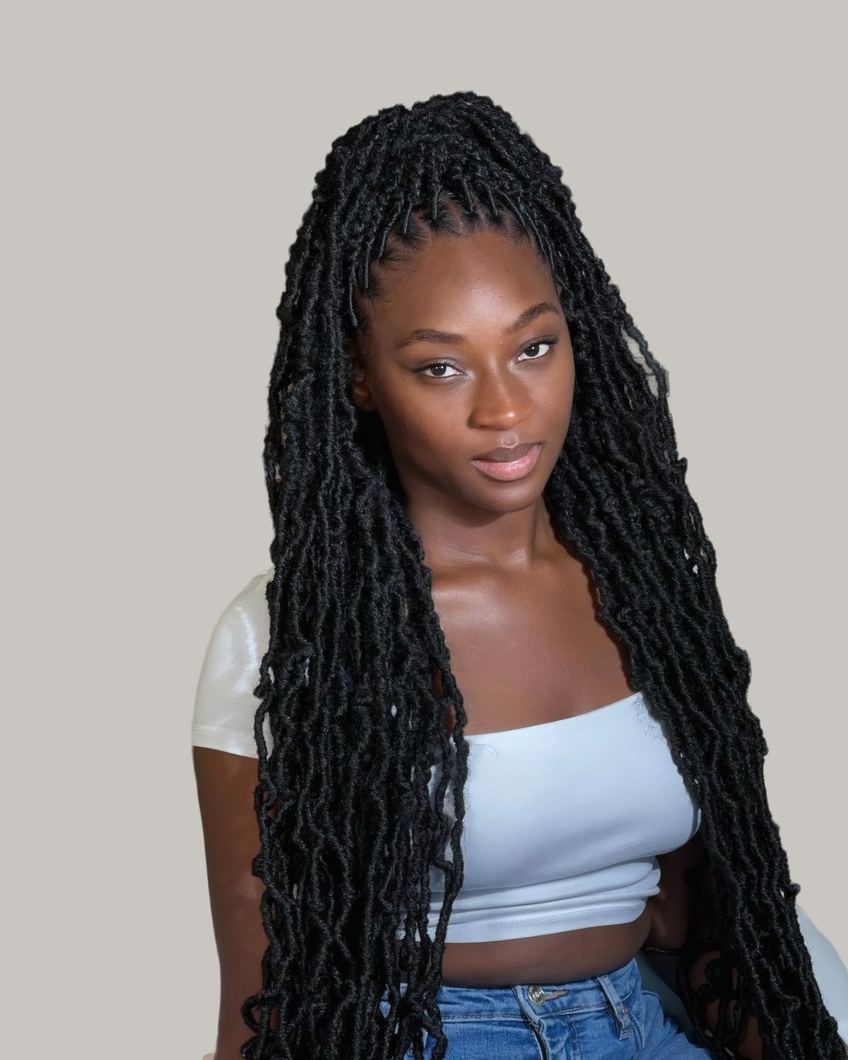 Woman with waist-length black soft locs worn down