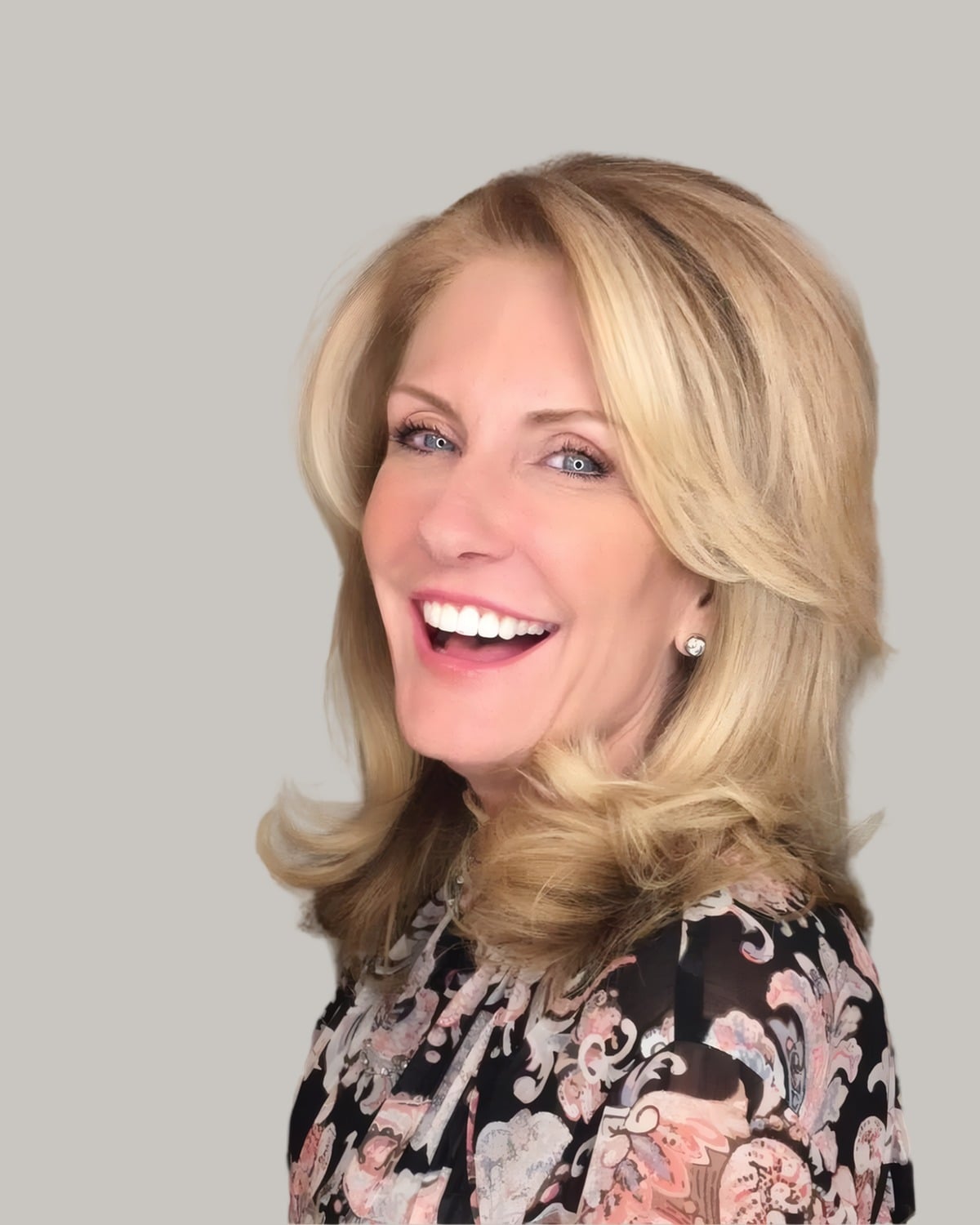 Laughing woman with bouncy blonde layers past the shoulders