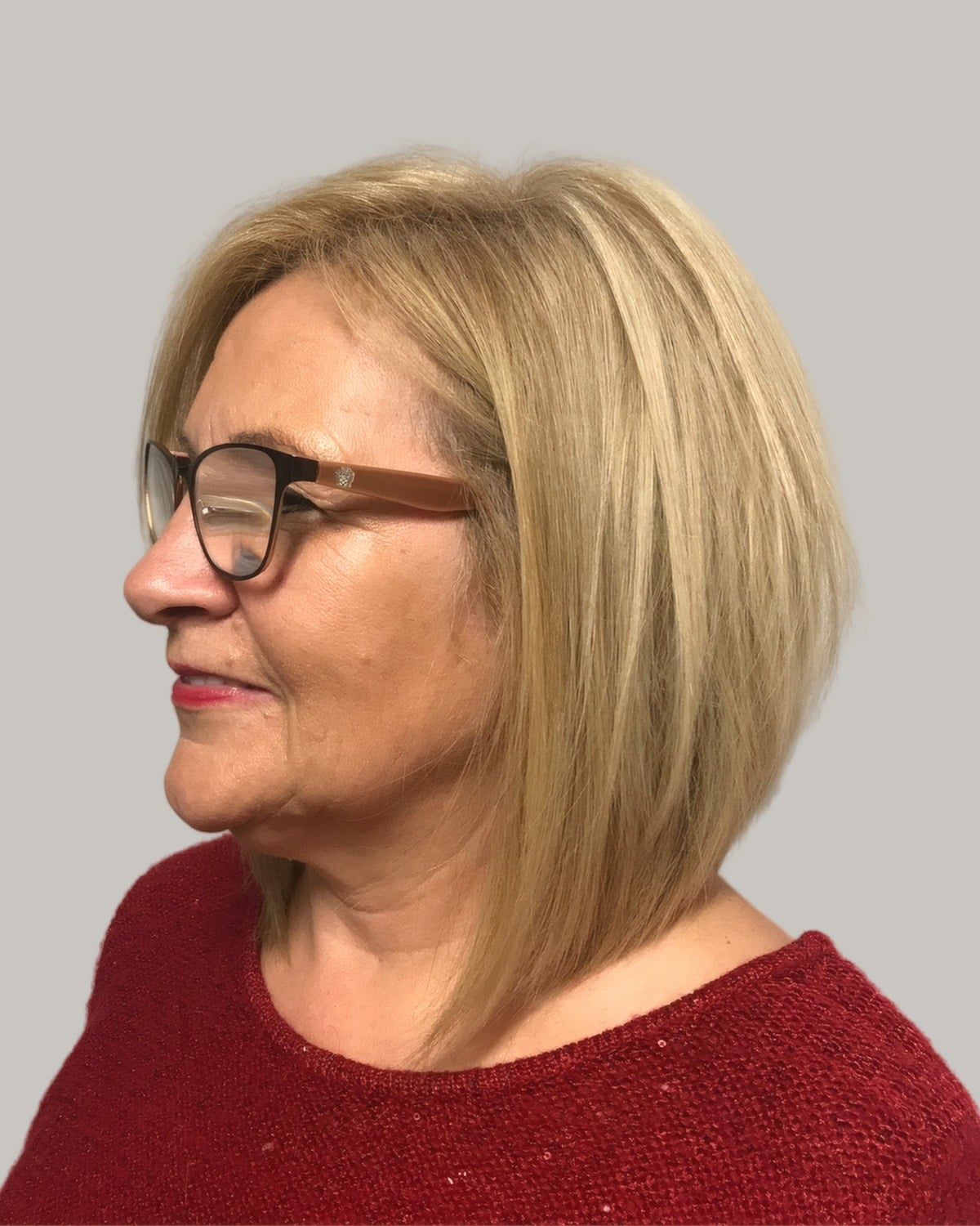 Woman with a blonde lob and tortoiseshell glasses, seen in profile
