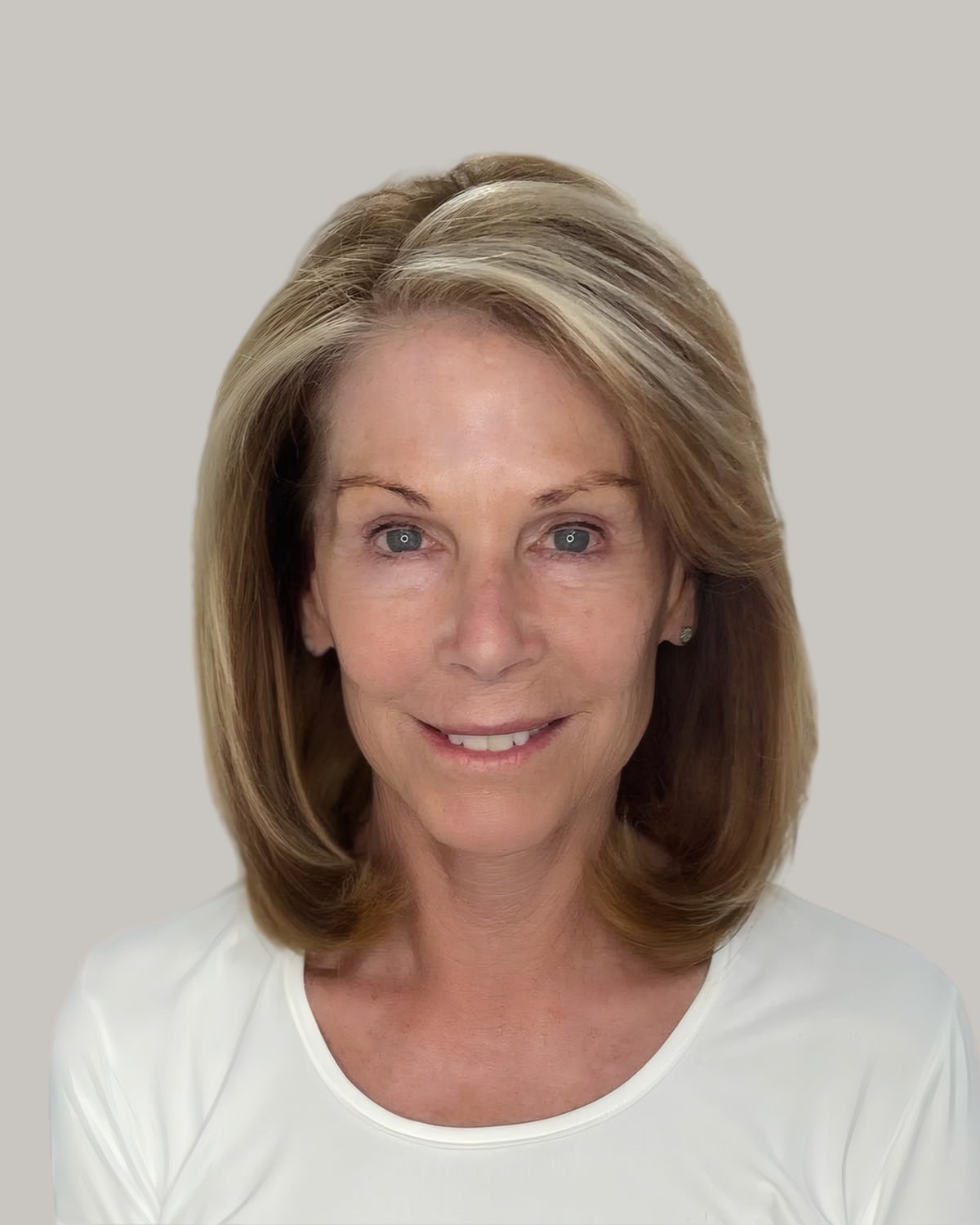 Smiling woman with shoulder-length light-brown hair parted at the side