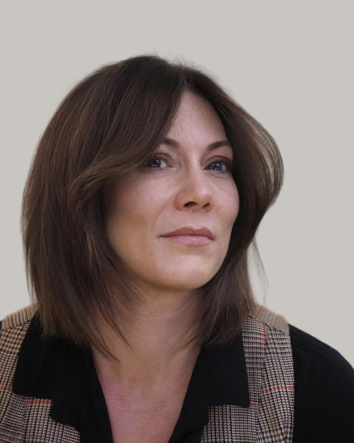 Woman with a dark-brown lob and curtain bangs