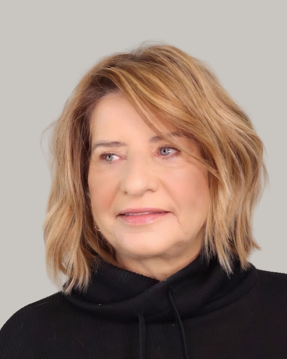 Woman with a copper-blonde wavy cut to the shoulders