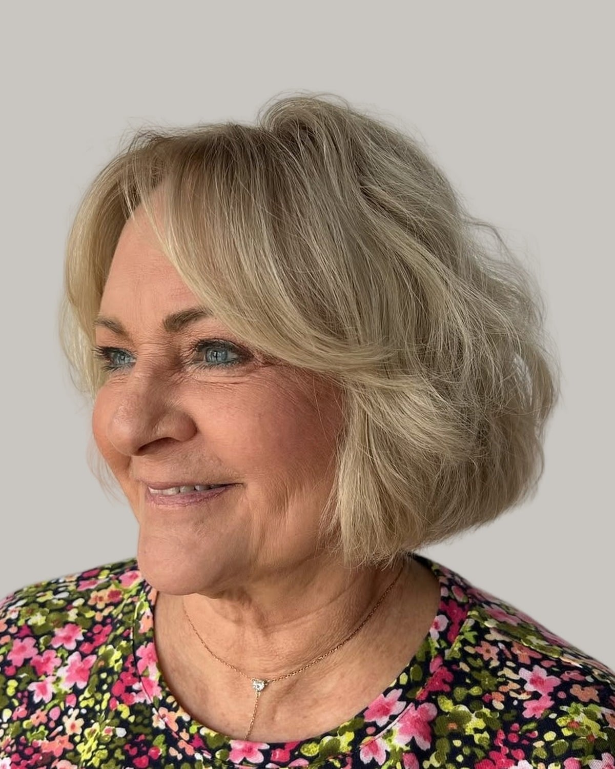 Smiling woman with a blonde wavy bob