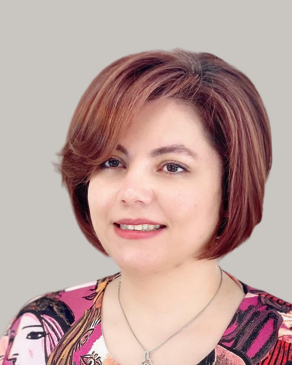Smiling woman with a copper bob swept to one side