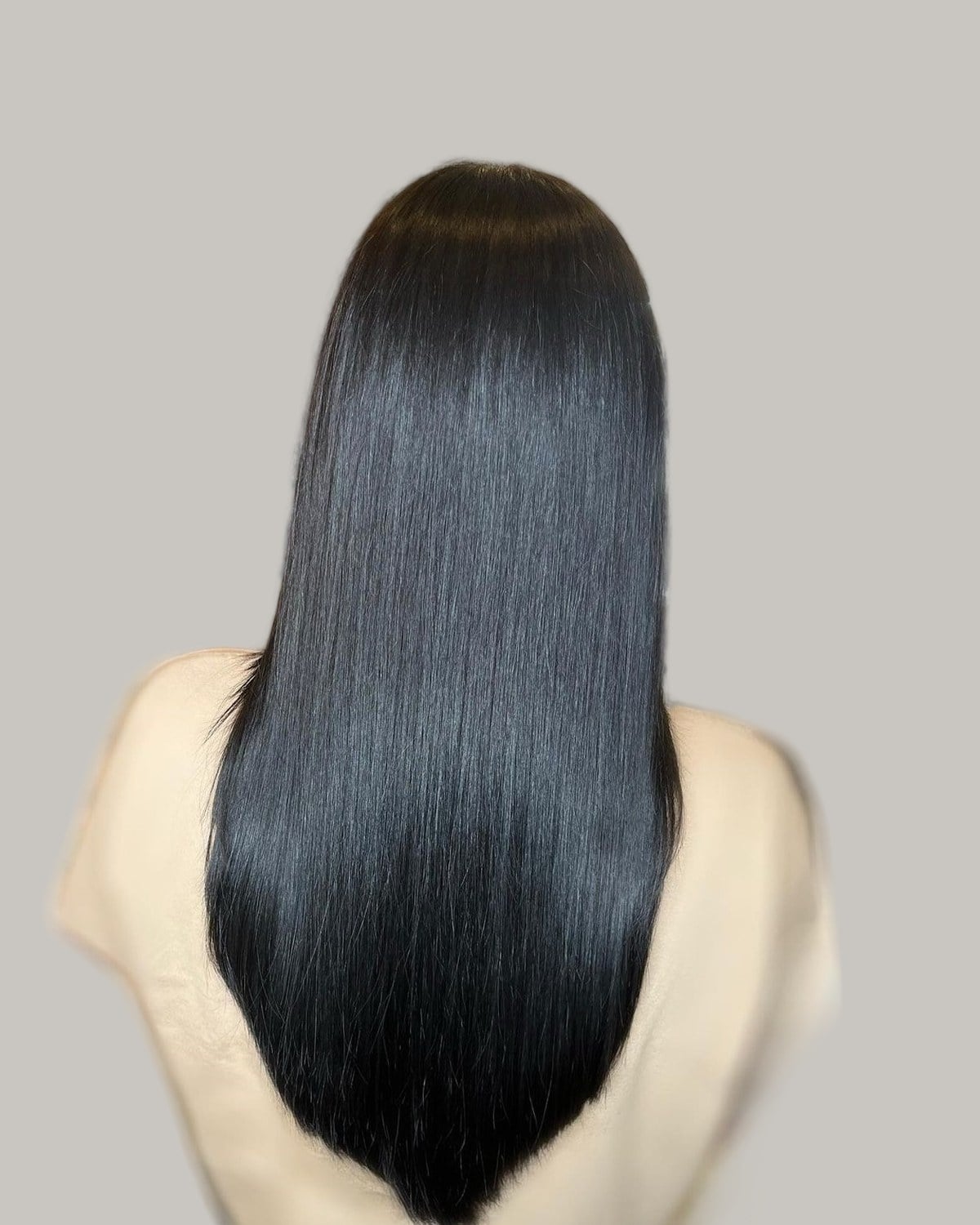 Long, straight black hair seen from the back, cut to a point