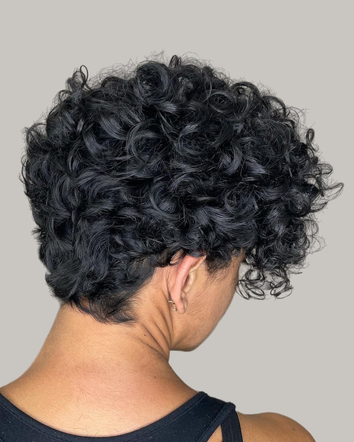 Woman with short dark curls, seen from behind