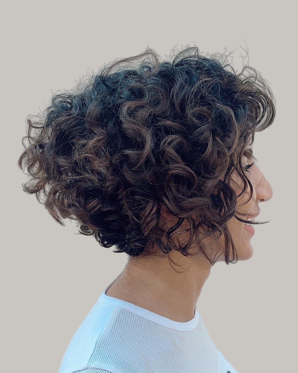 Woman with a curly bob seen from the side