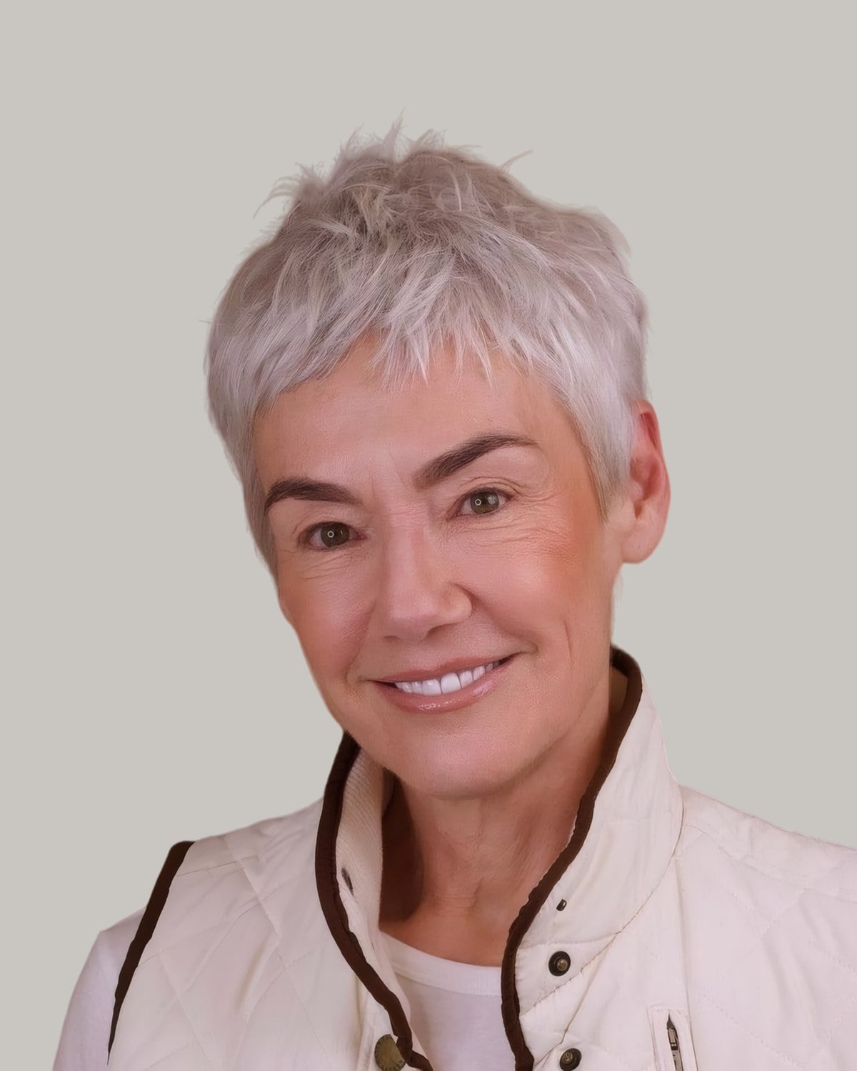 Smiling woman with a short silver-gray pixie