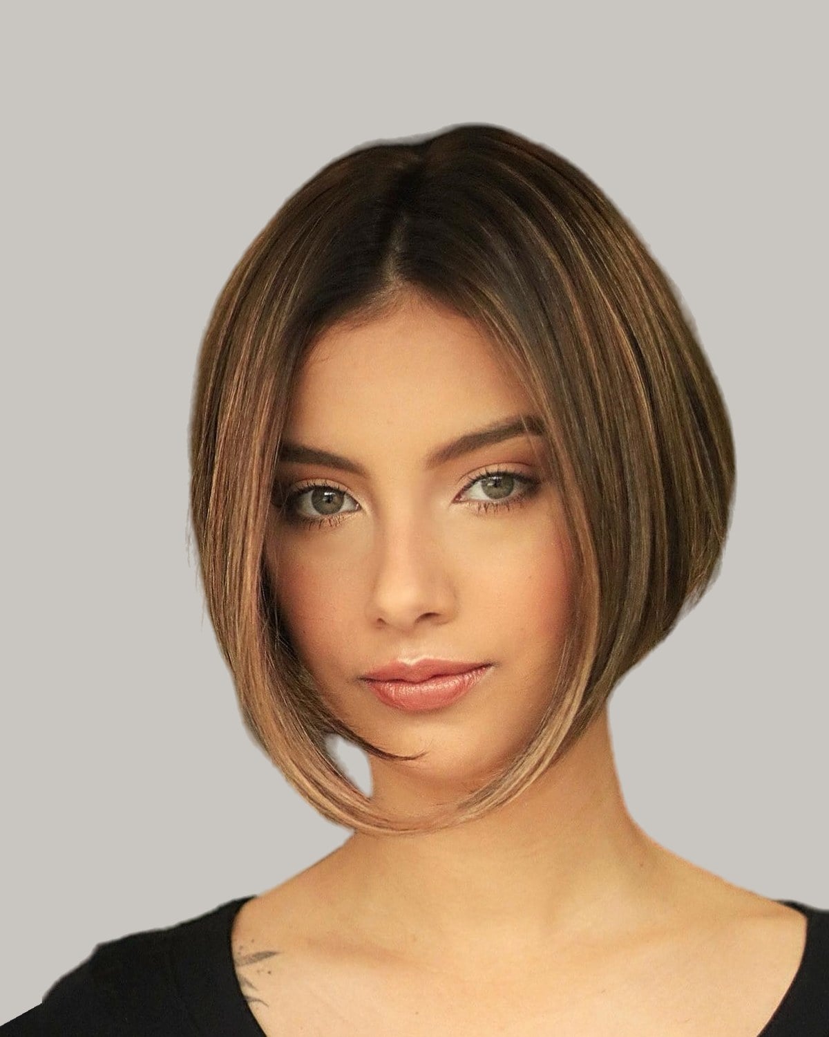 Woman with a brown inverted bob and a middle part, facing the camera