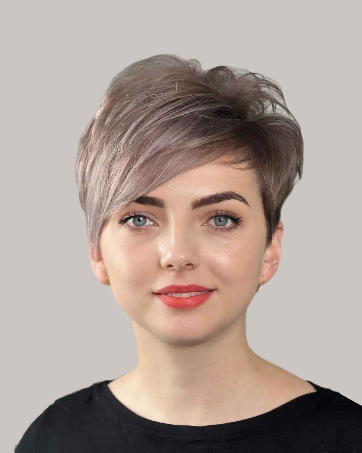 Woman with an ash-blonde long pixie and a side-swept fringe