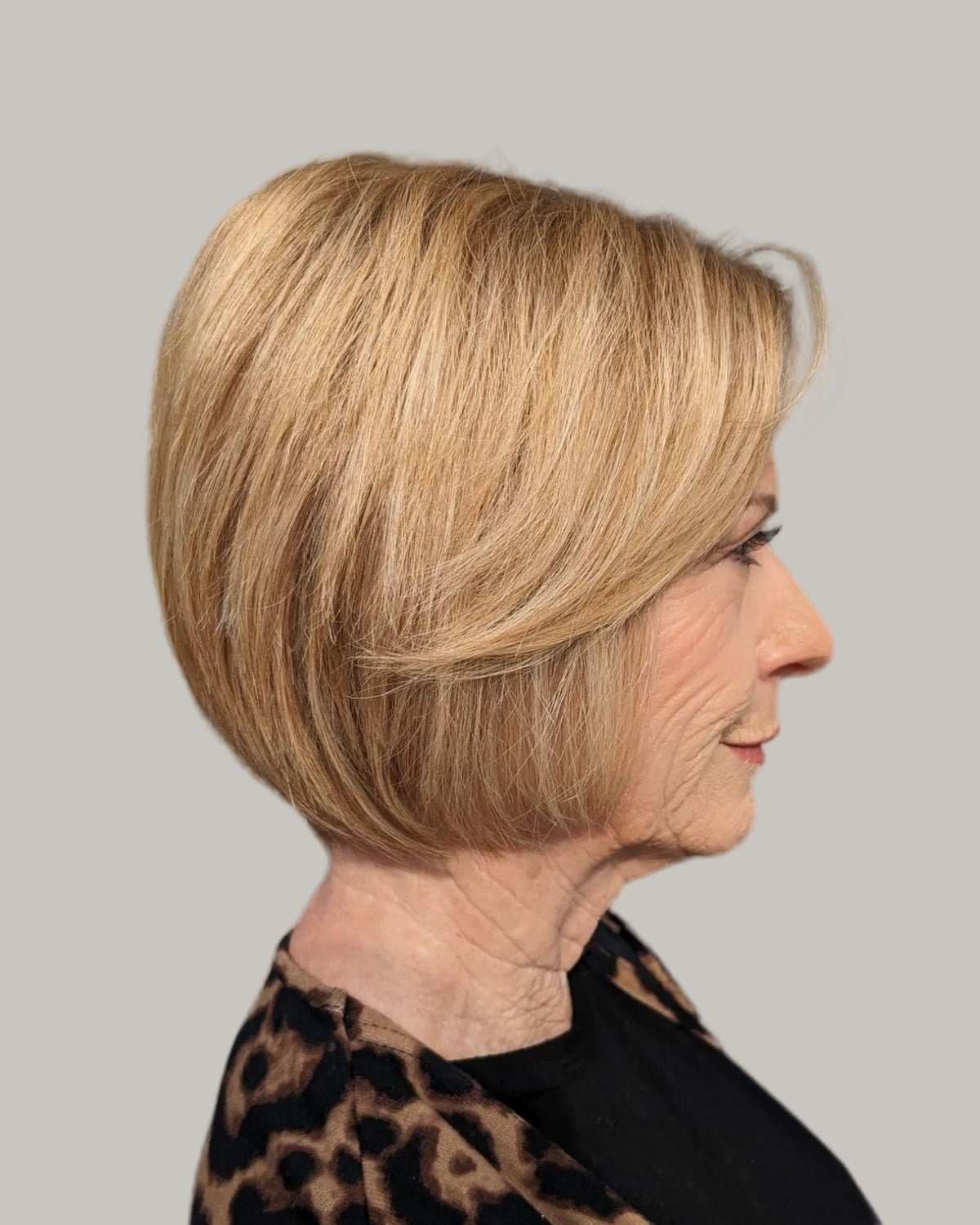 Woman with a honey-blonde bob, seen in profile