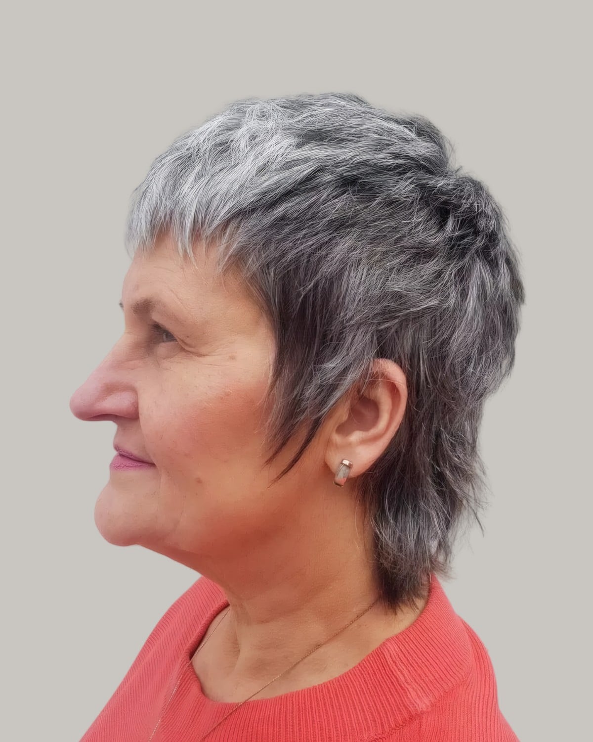 Woman with a short gray mixie, seen in profile