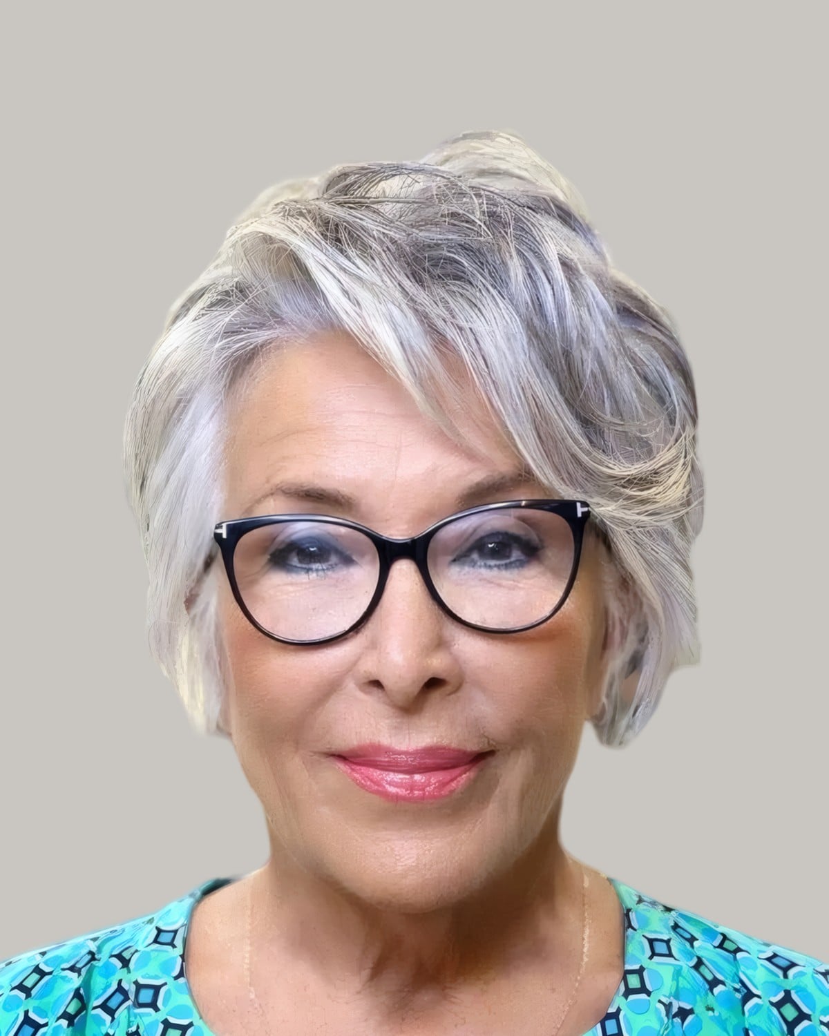 Smiling woman with a voluminous silver short cut and black cat-eye glasses