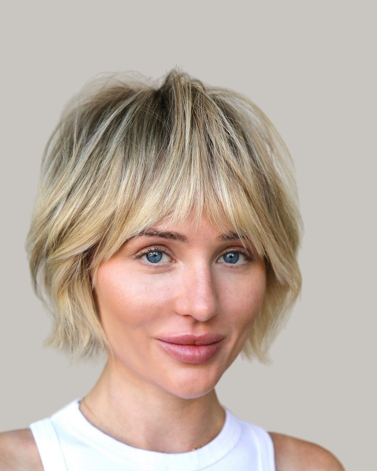Woman with a choppy blonde shag and wispy bangs