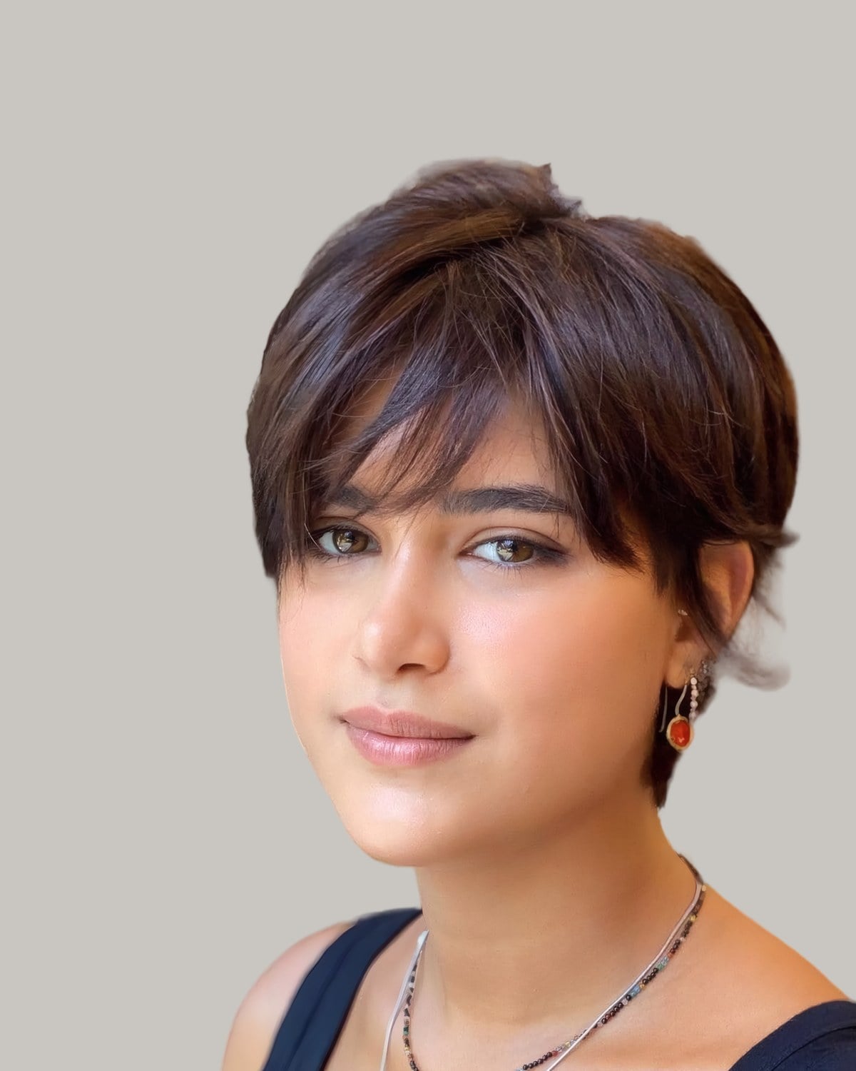 Woman with a brown short cut and full bangs, facing the camera