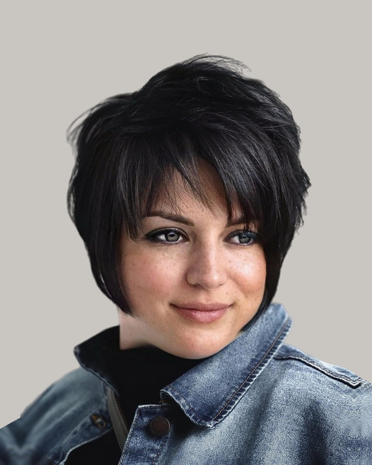 Woman with a black layered bixie and bangs, facing the camera