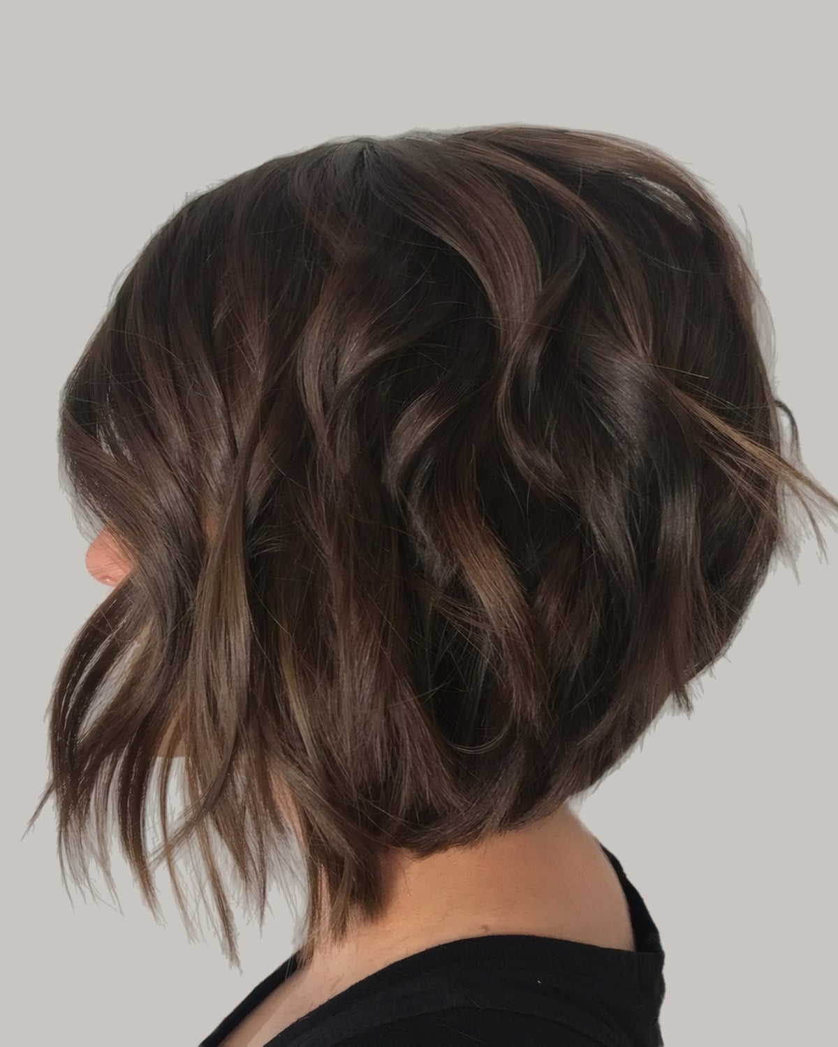 Woman with a wavy brown bob seen from behind