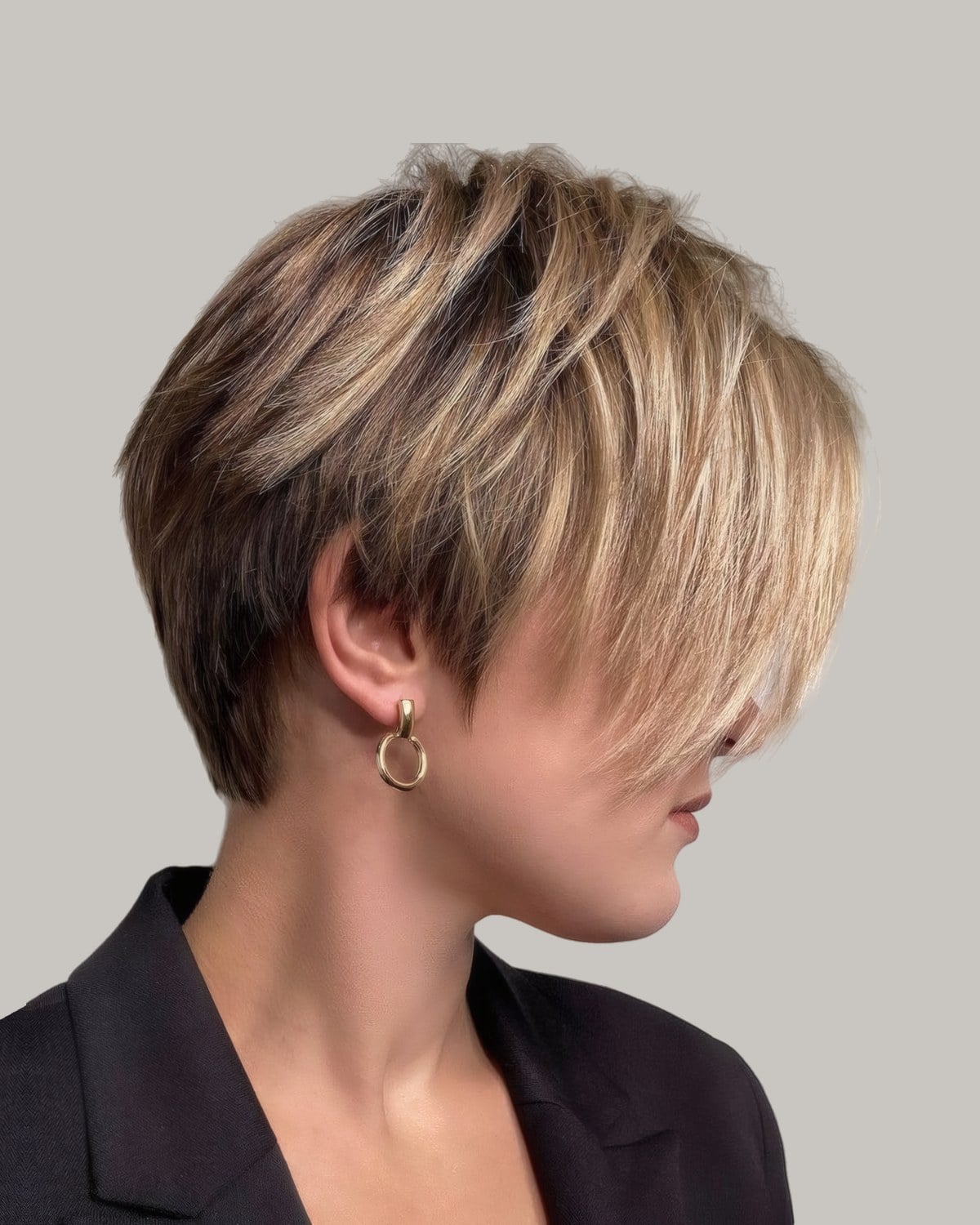 Woman with a highlighted pixie and a long side fringe, in profile